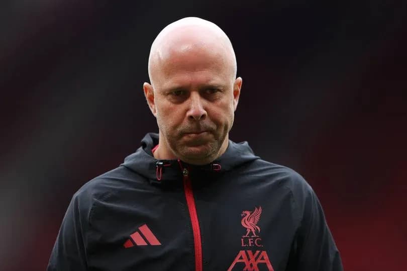 Liverpool coach walking on the pitch before match Liverpool coach walking on the pitch before match