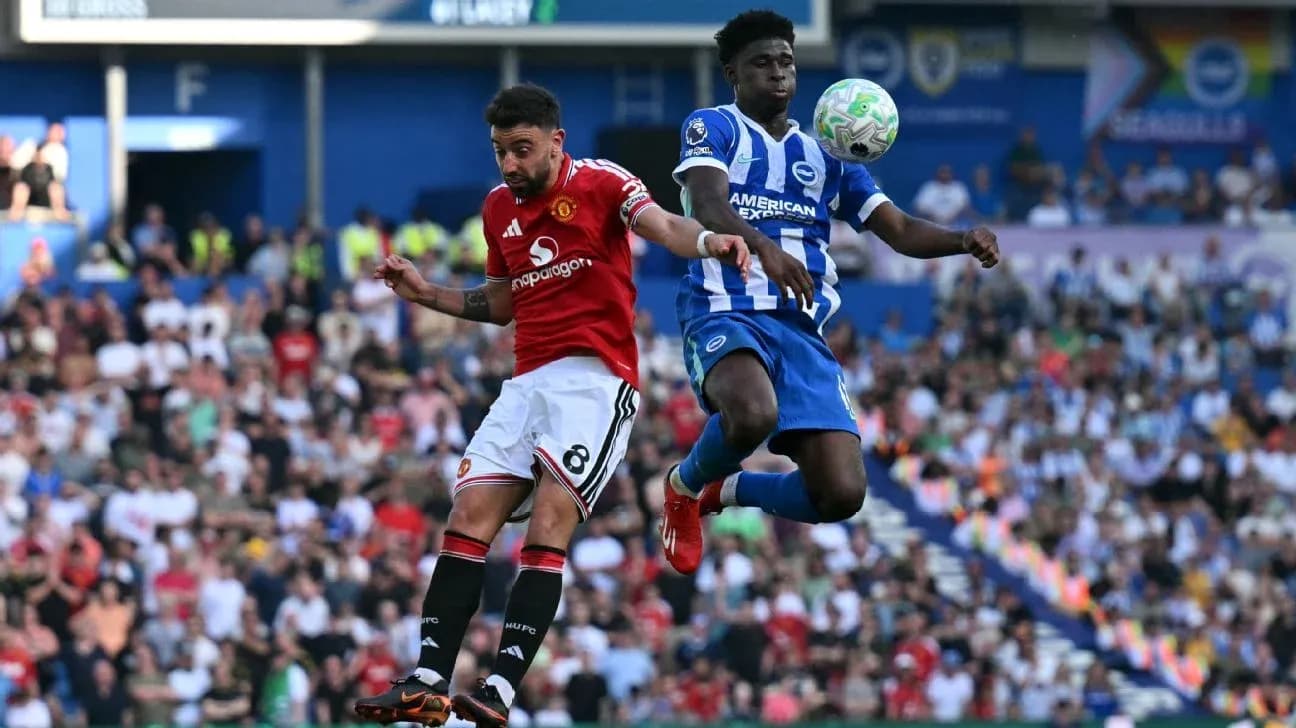 Player from Manchester United and Brighton competing for the ball Player from Manchester United and Brighton competing for the ball