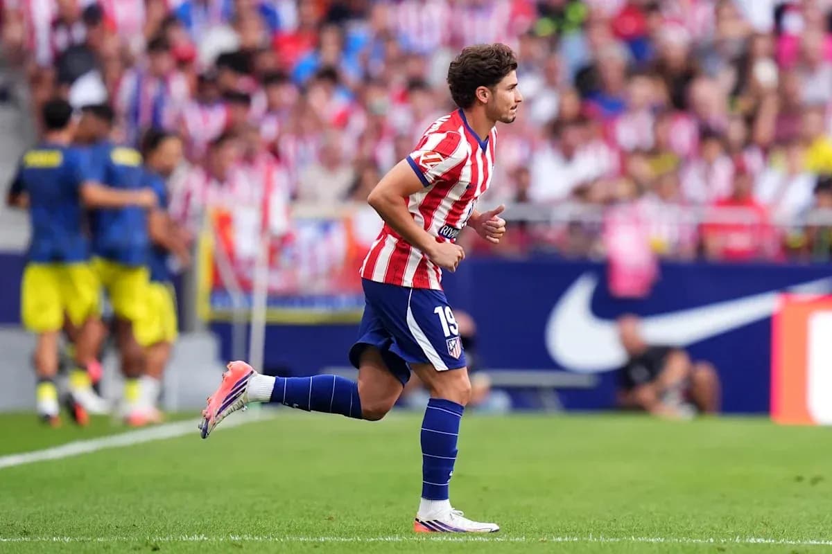 Atletico Madrid player running on the field Atletico Madrid player running on the field