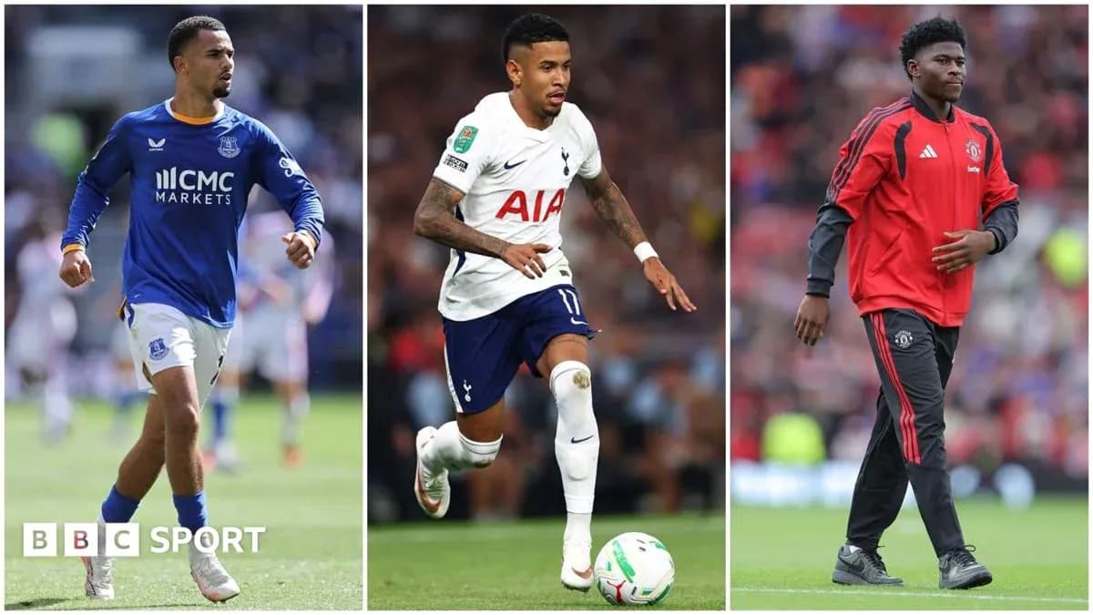 Three football players in club kits during match Three football players in club kits during match