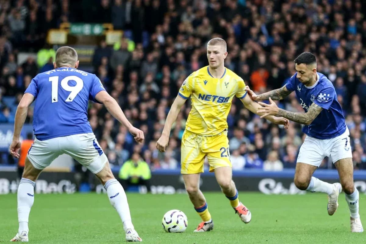 Players contesting possession during a football match Players contesting possession during a football match