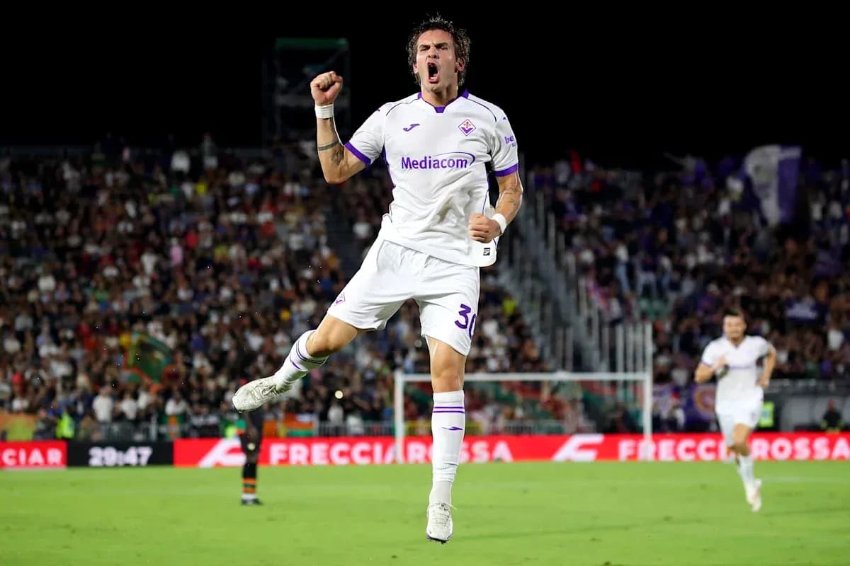 Fiorentina player celebrating goal in front of crowd Fiorentina player celebrating goal in front of crowd