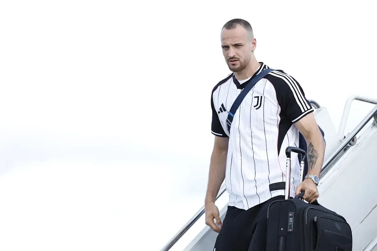 Player arriving at airport with suitcase Player arriving at airport with suitcase