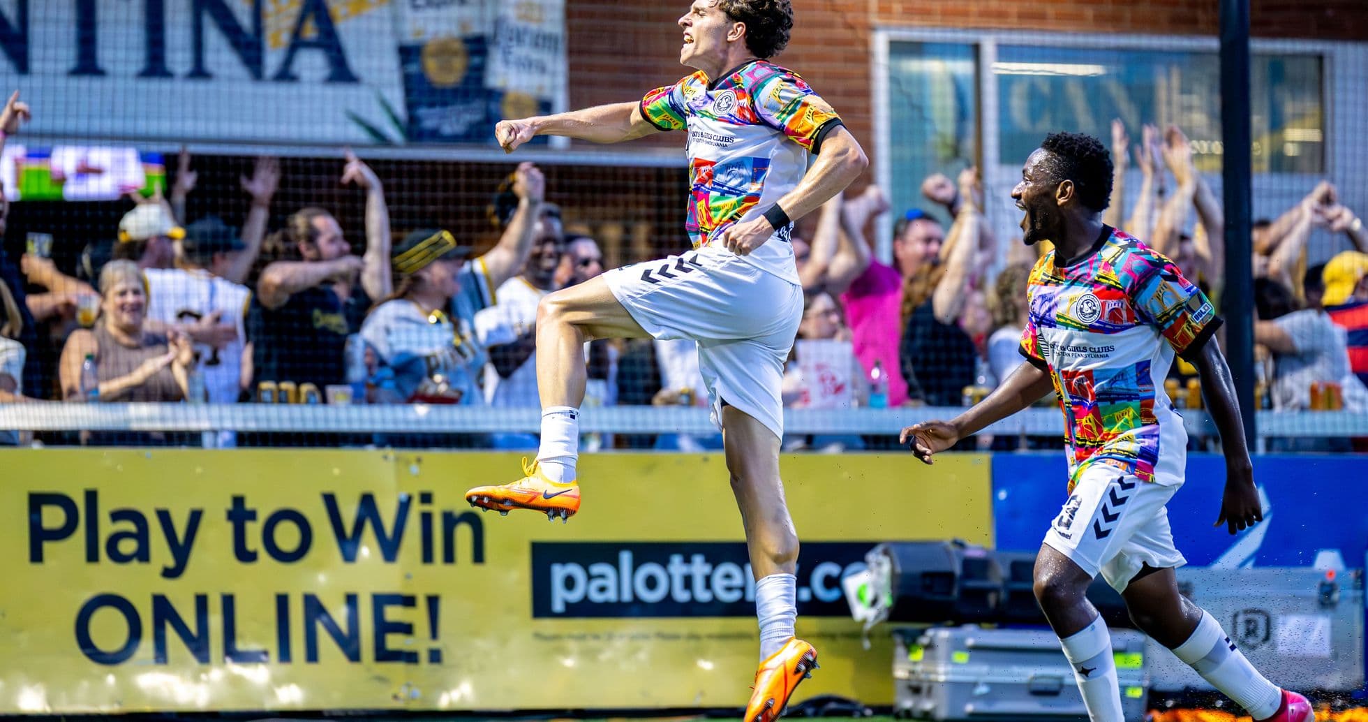 Player celebrating goal with teammates in match Player celebrating goal with teammates in match