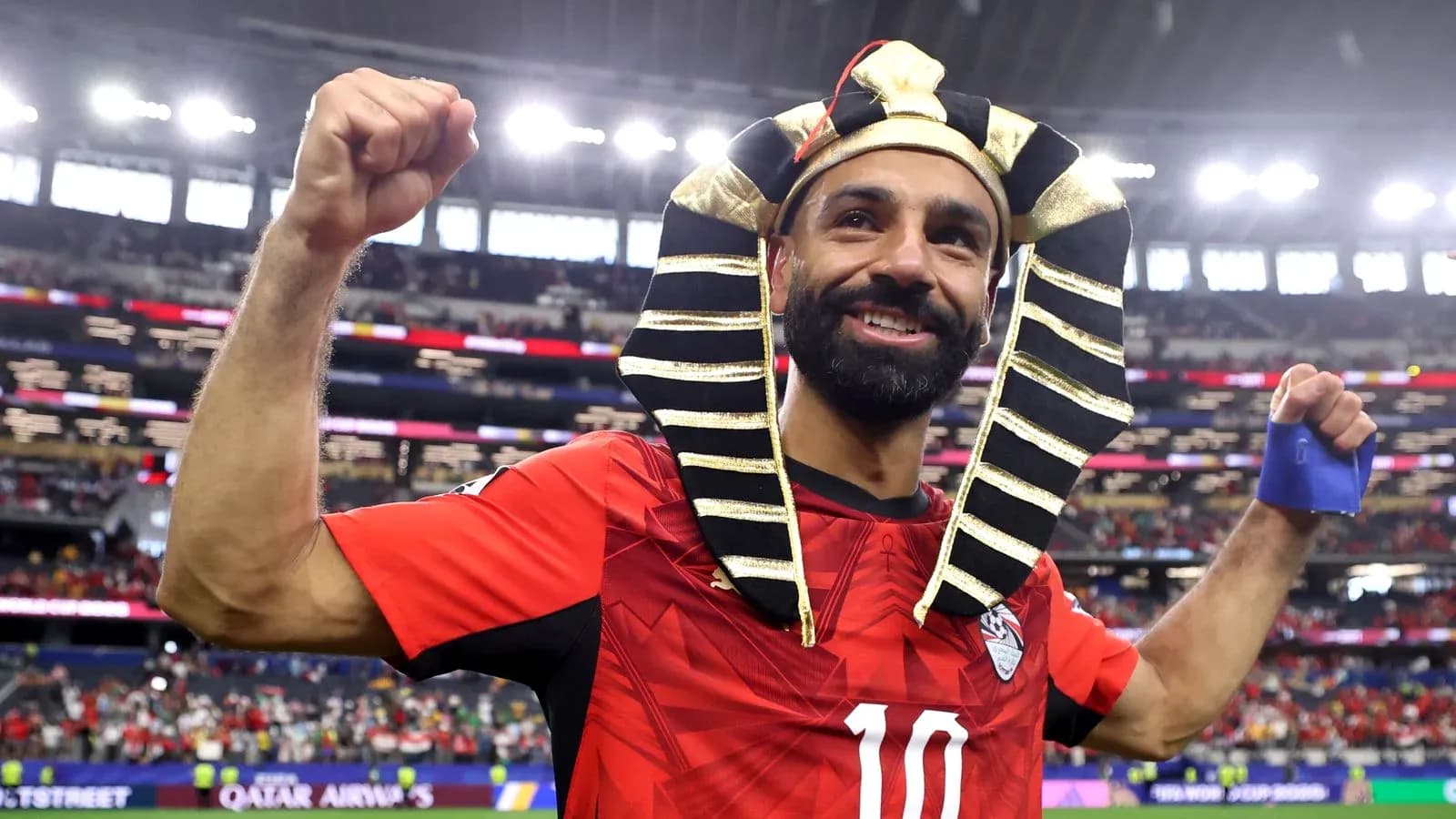 Player celebrating in red jersey with pharaoh headdress Player celebrating in red jersey with pharaoh headdress