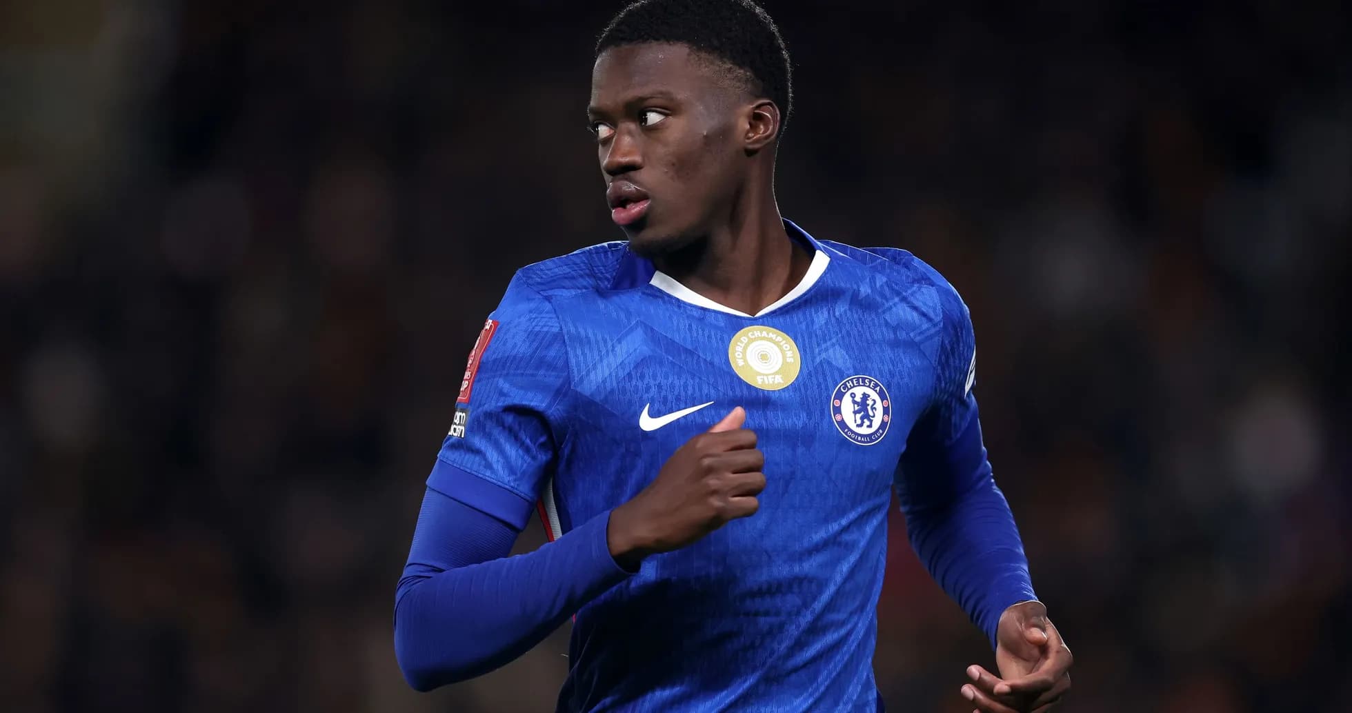 Chelsea player running during a football match Chelsea player running during a football match