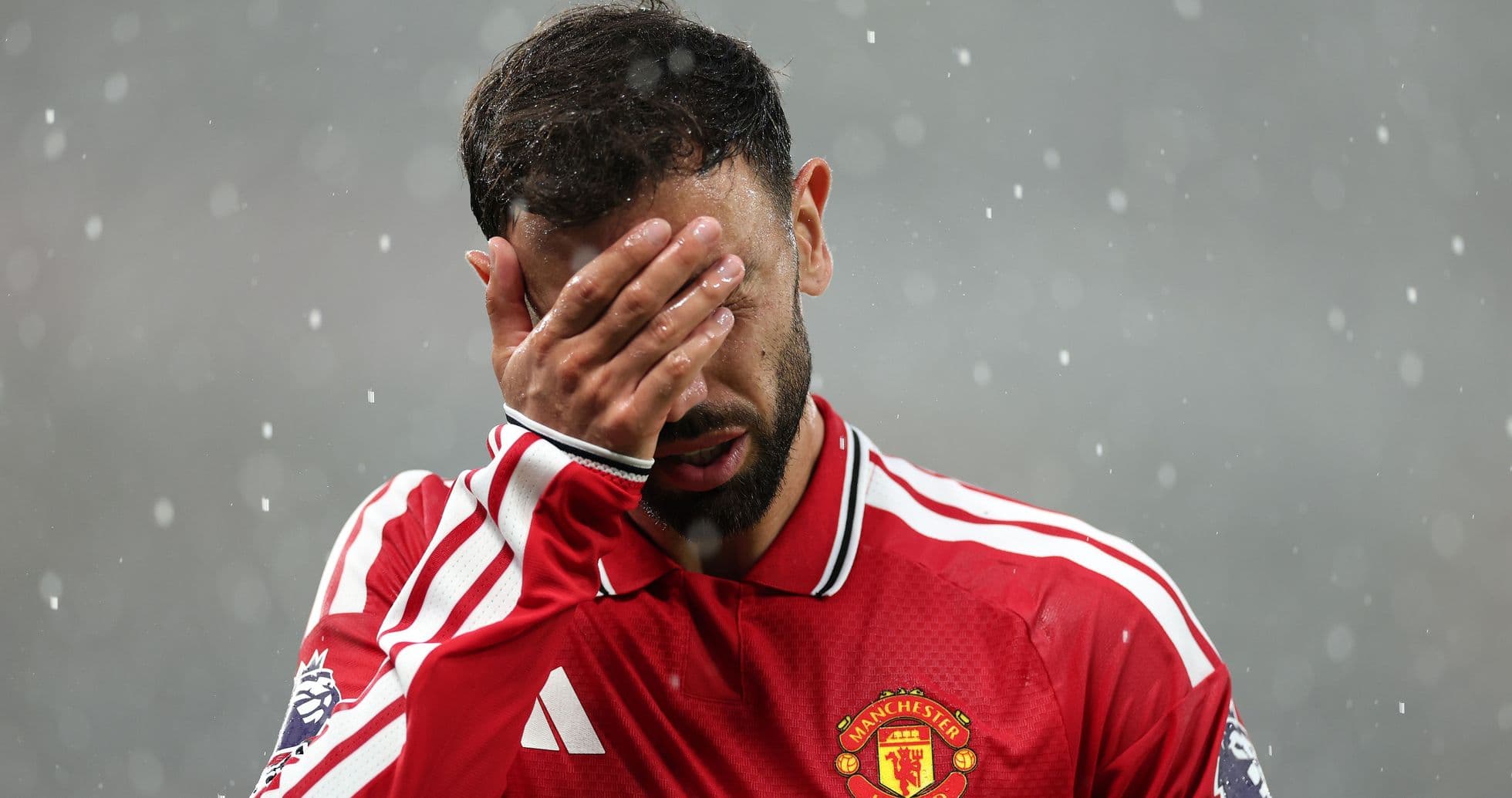 Bruno Fernandes covering his face in rain Bruno Fernandes covering his face in rain