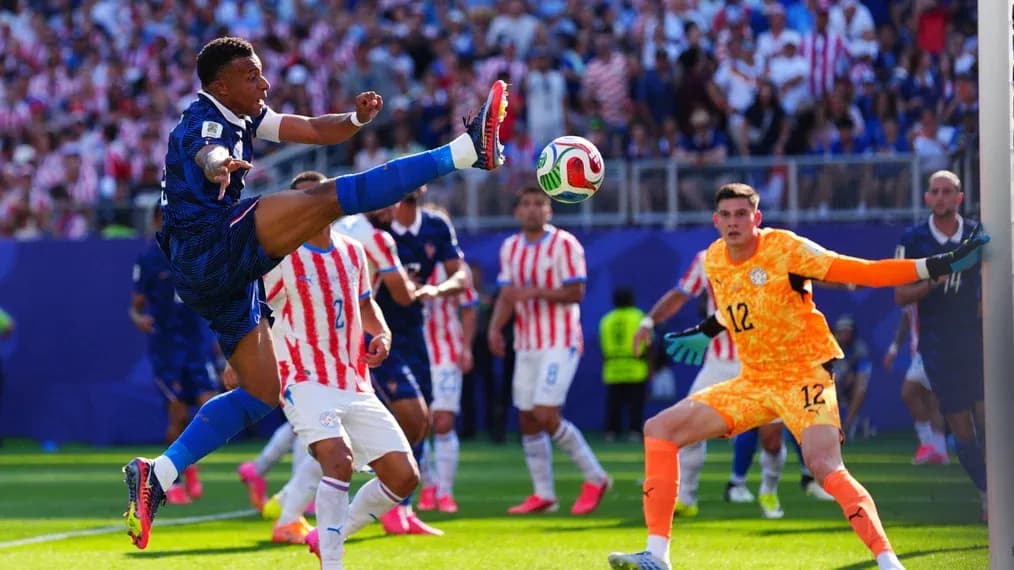 Player kicking ball during match with goalkeeper ready Player kicking ball during match with goalkeeper ready