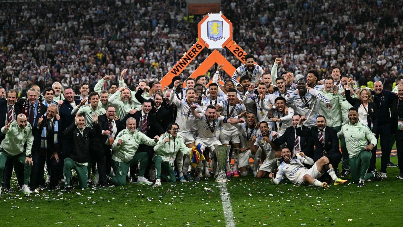 Team celebrating victory with trophy at stadium Team celebrating victory with trophy at stadium