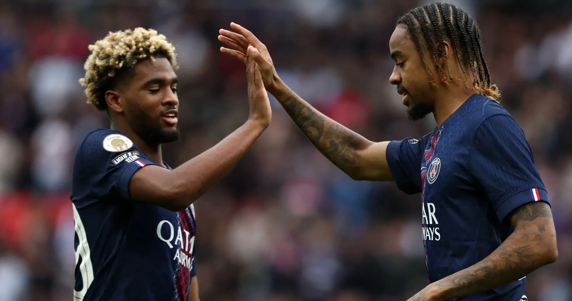 Two PSG players celebrating with a high five Two PSG players celebrating with a high five