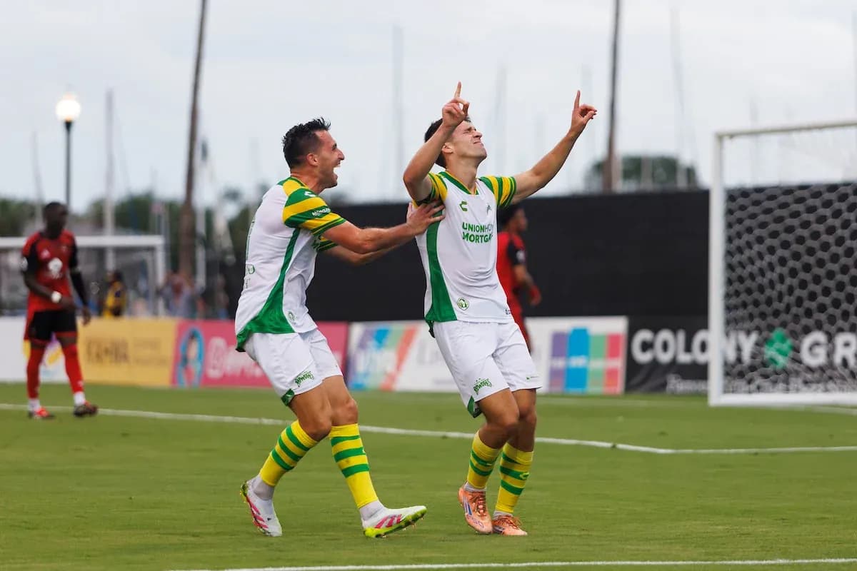 Players celebrating a goal during a match Players celebrating a goal during a match