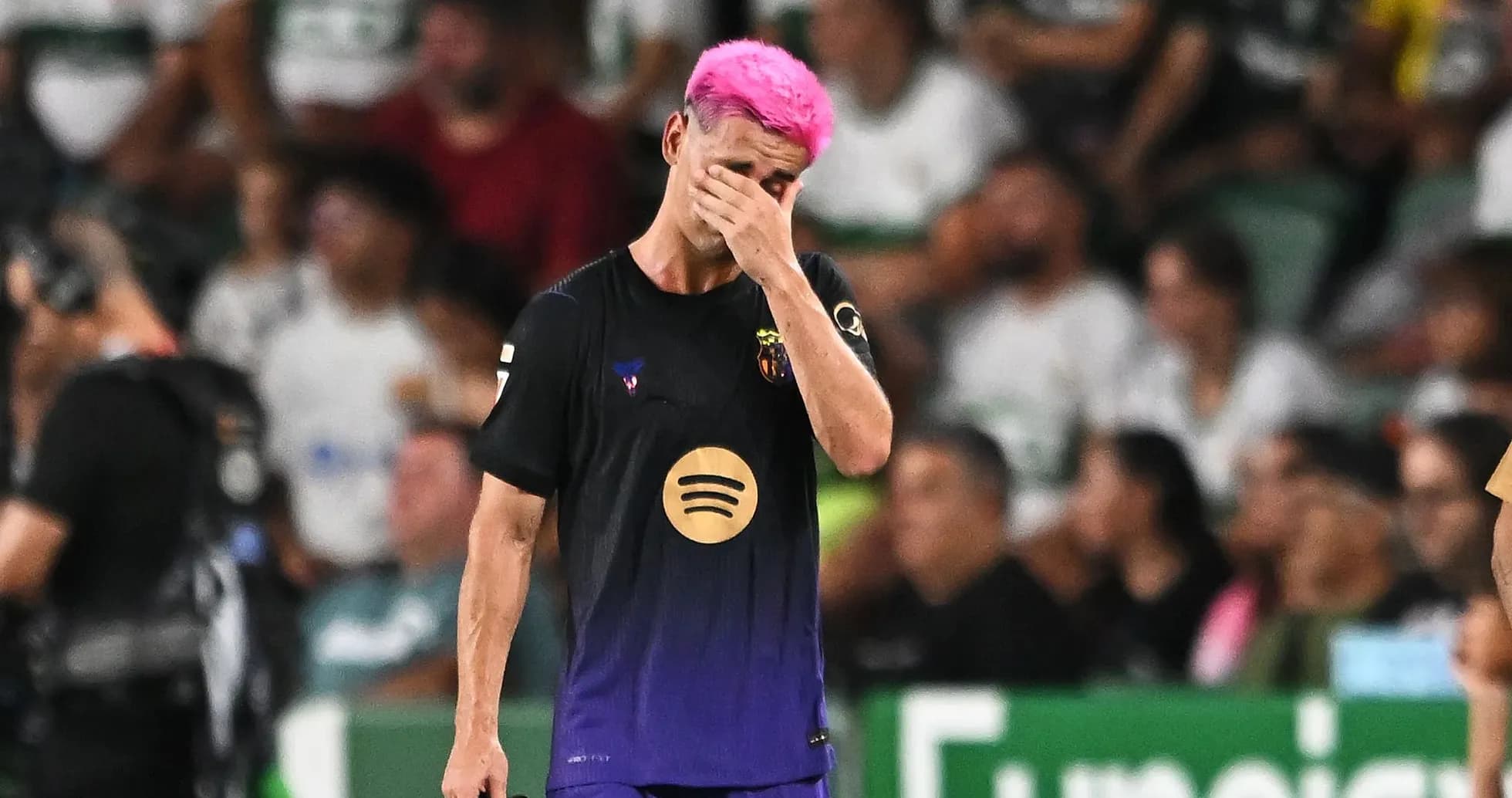 Player with pink hair covering face during match Player with pink hair covering face during match