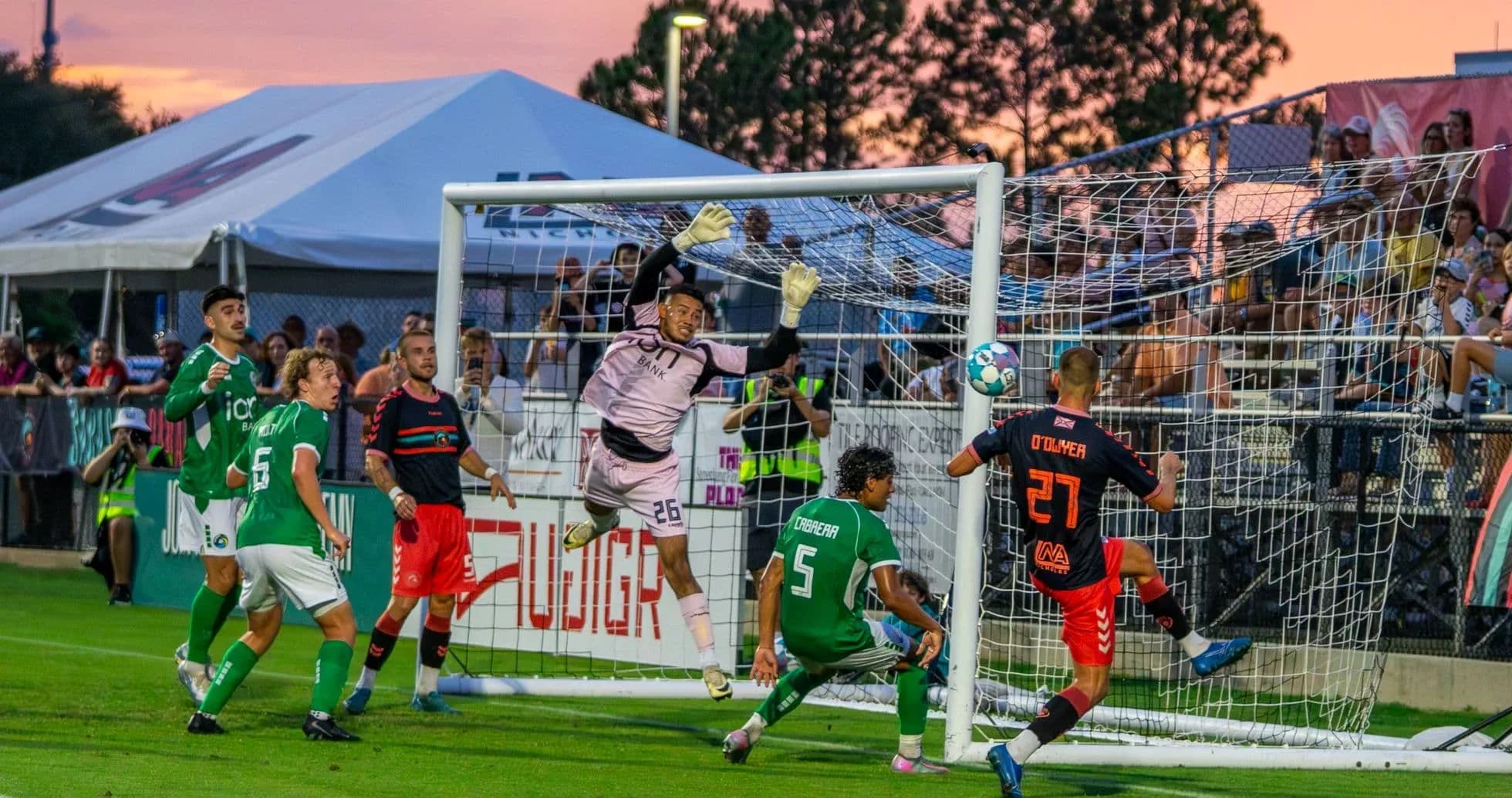 Goalkeeper attempting to save during match Goalkeeper attempting to save during match