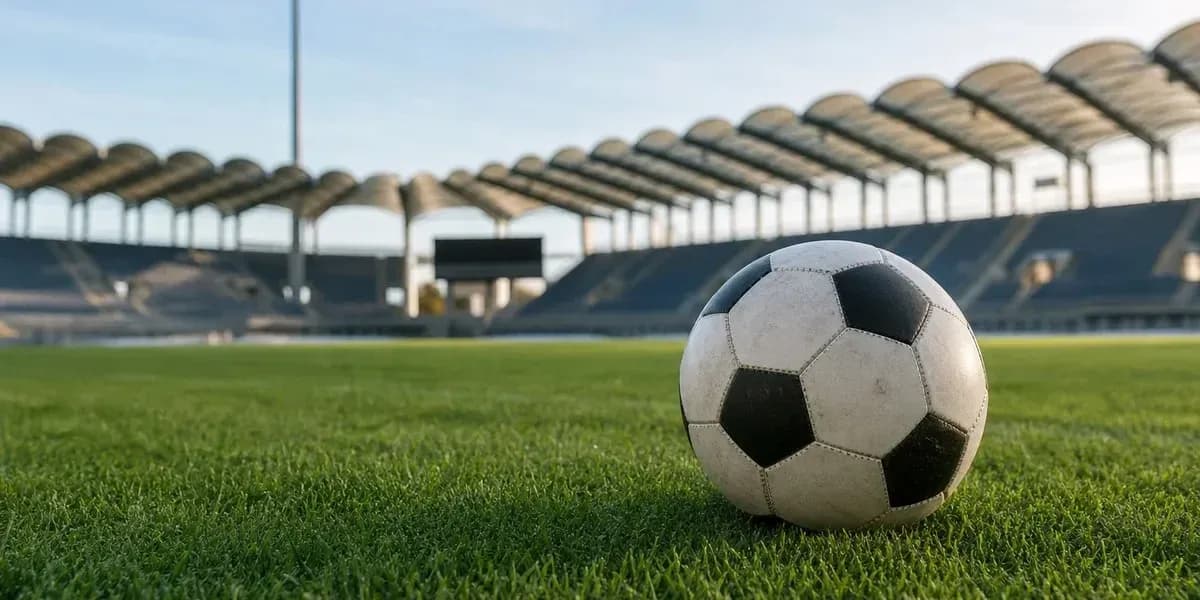 Soccer ball on grass field in empty stadium Soccer ball on grass field in empty stadium
