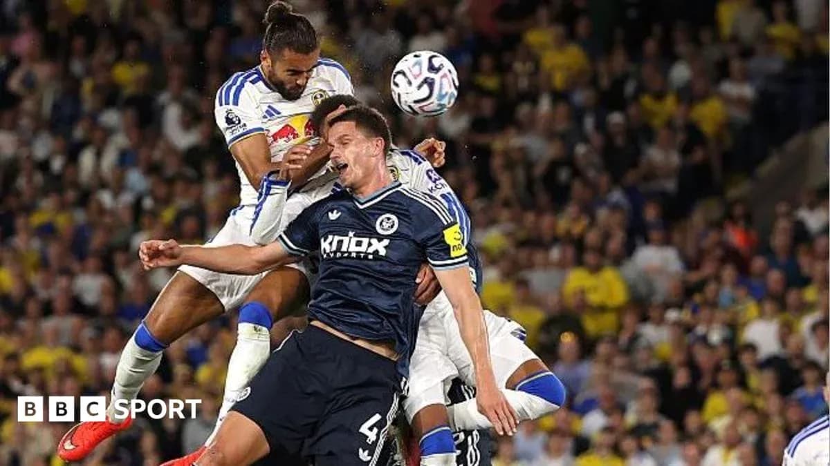 Players challenging for the ball during a match Players challenging for the ball during a match