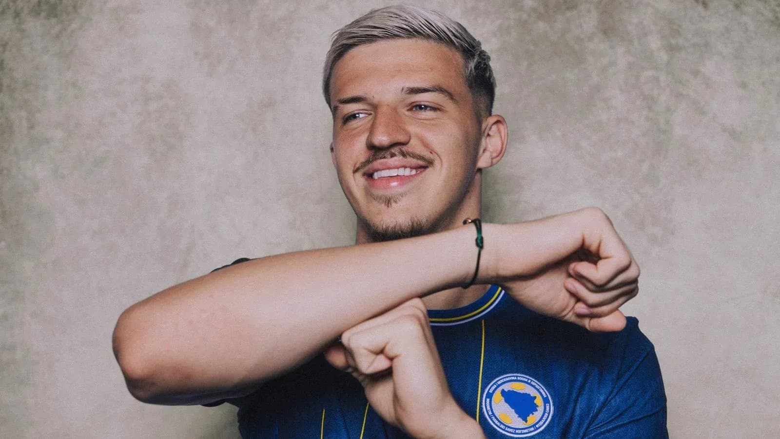 Player smiling while wearing national team jersey Player smiling while wearing national team jersey