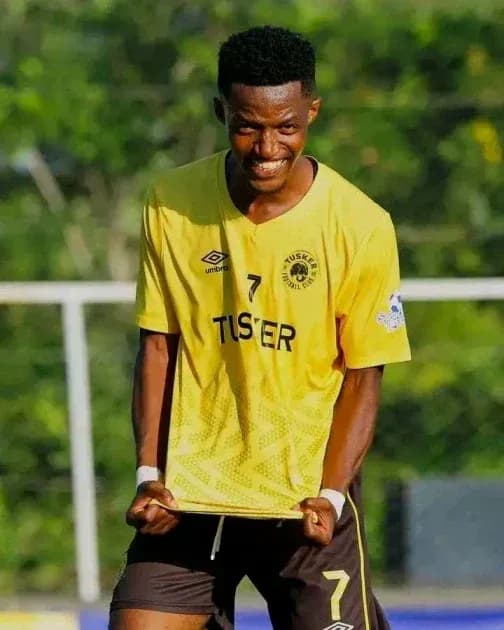 Player celebrating in yellow jersey with fists raised Player celebrating in yellow jersey with fists raised