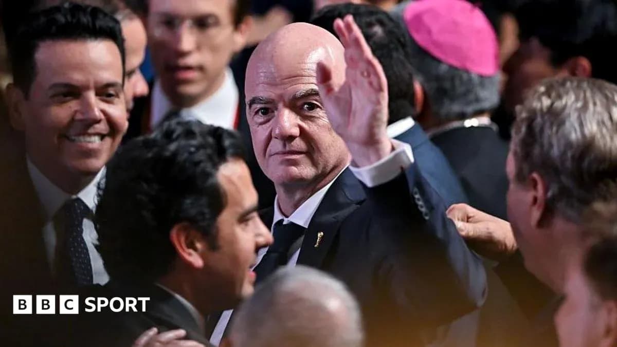 Gianni Infantino waving in crowded event setting Gianni Infantino waving in crowded event setting
