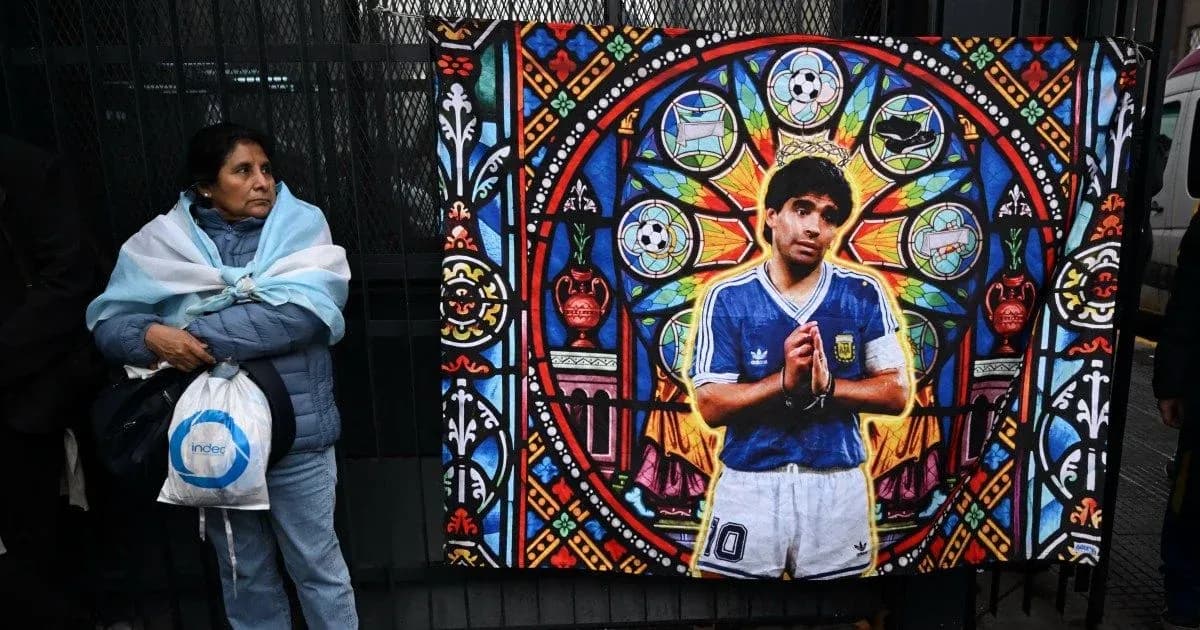 Woman with Argentine flag near Diego Maradona mural Woman with Argentine flag near Diego Maradona mural