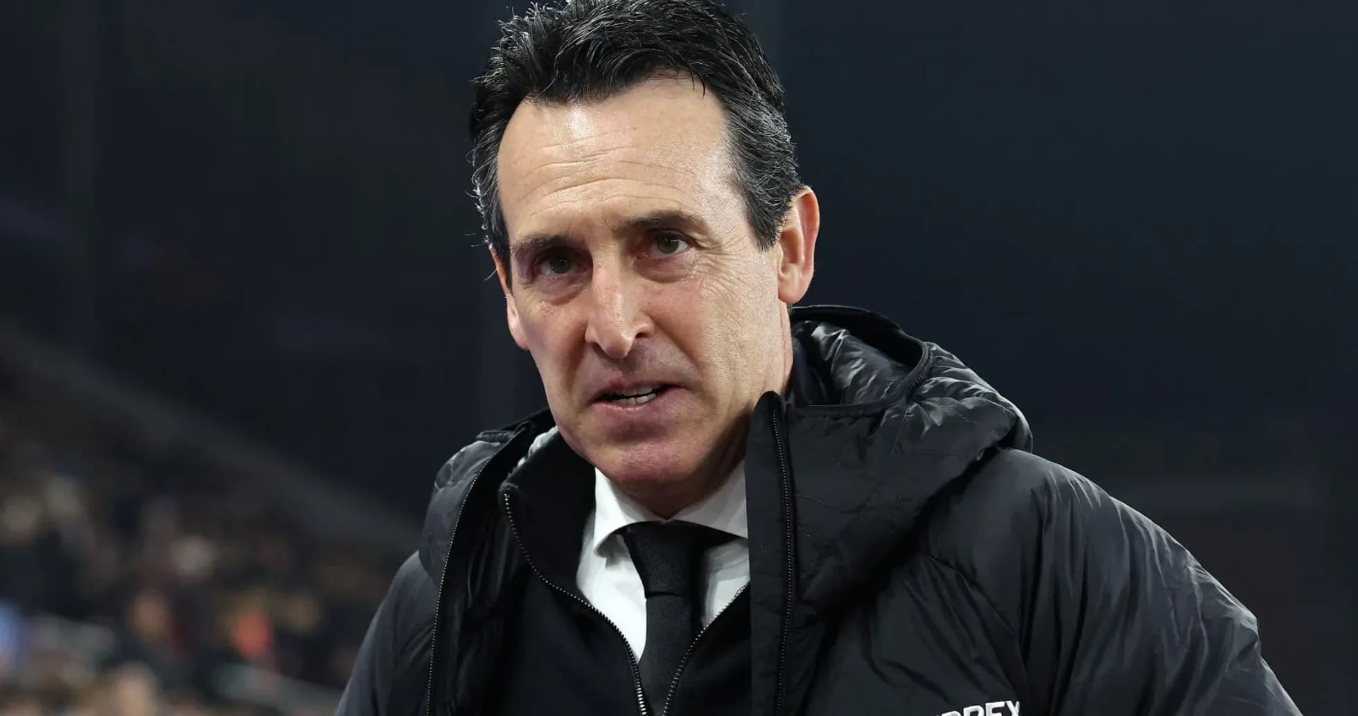 Coach in black jacket during match Coach in black jacket during match