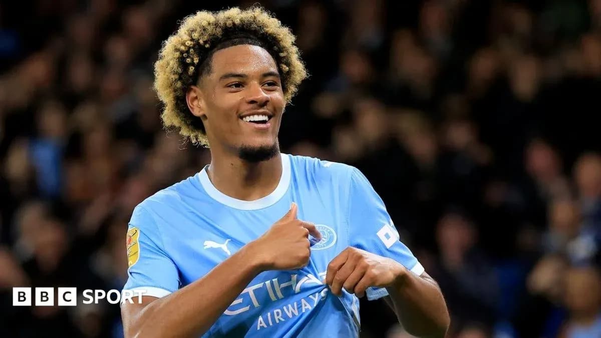 Player celebrating in Manchester City kit Player celebrating in Manchester City kit