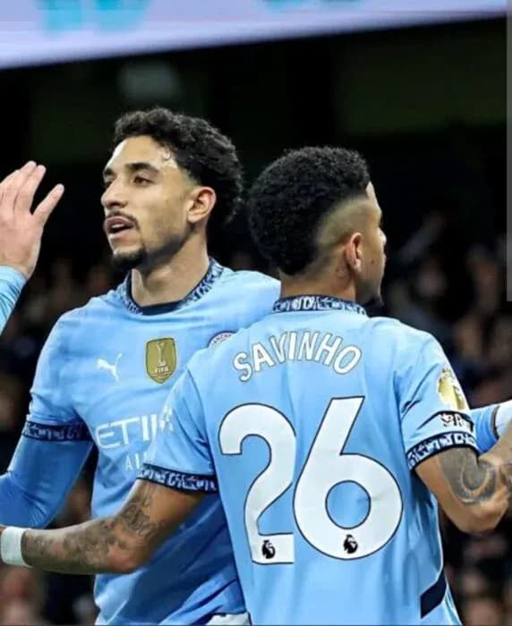 Two Manchester City players celebrating on the field Two Manchester City players celebrating on the field