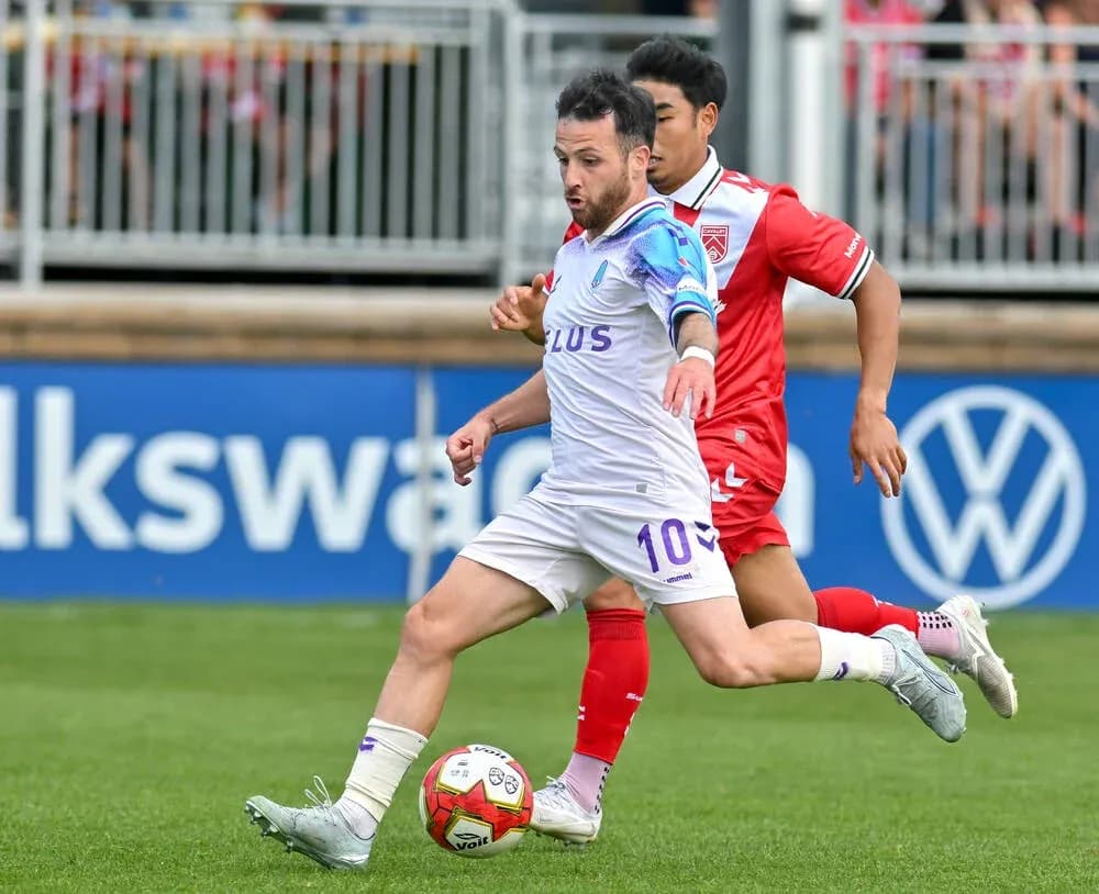Player dribbling the ball during Cavalry FC match Player dribbling the ball during Cavalry FC match