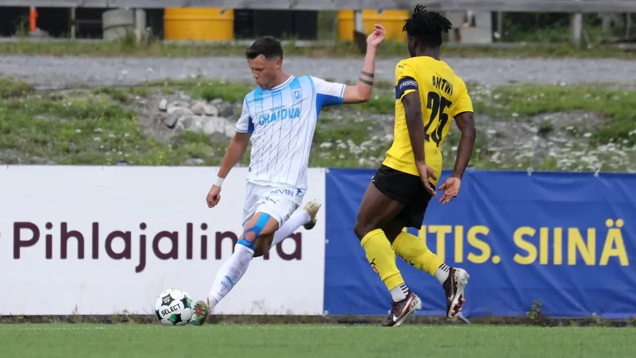 Universitatea Craiova player challenging KuPS opponent Universitatea Craiova player challenging KuPS opponent