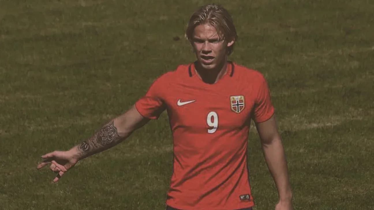 Player gesturing on the field in red jersey Player gesturing on the field in red jersey