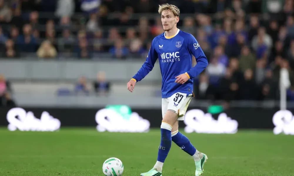 Player wearing blue kit walking on the pitch Player wearing blue kit walking on the pitch