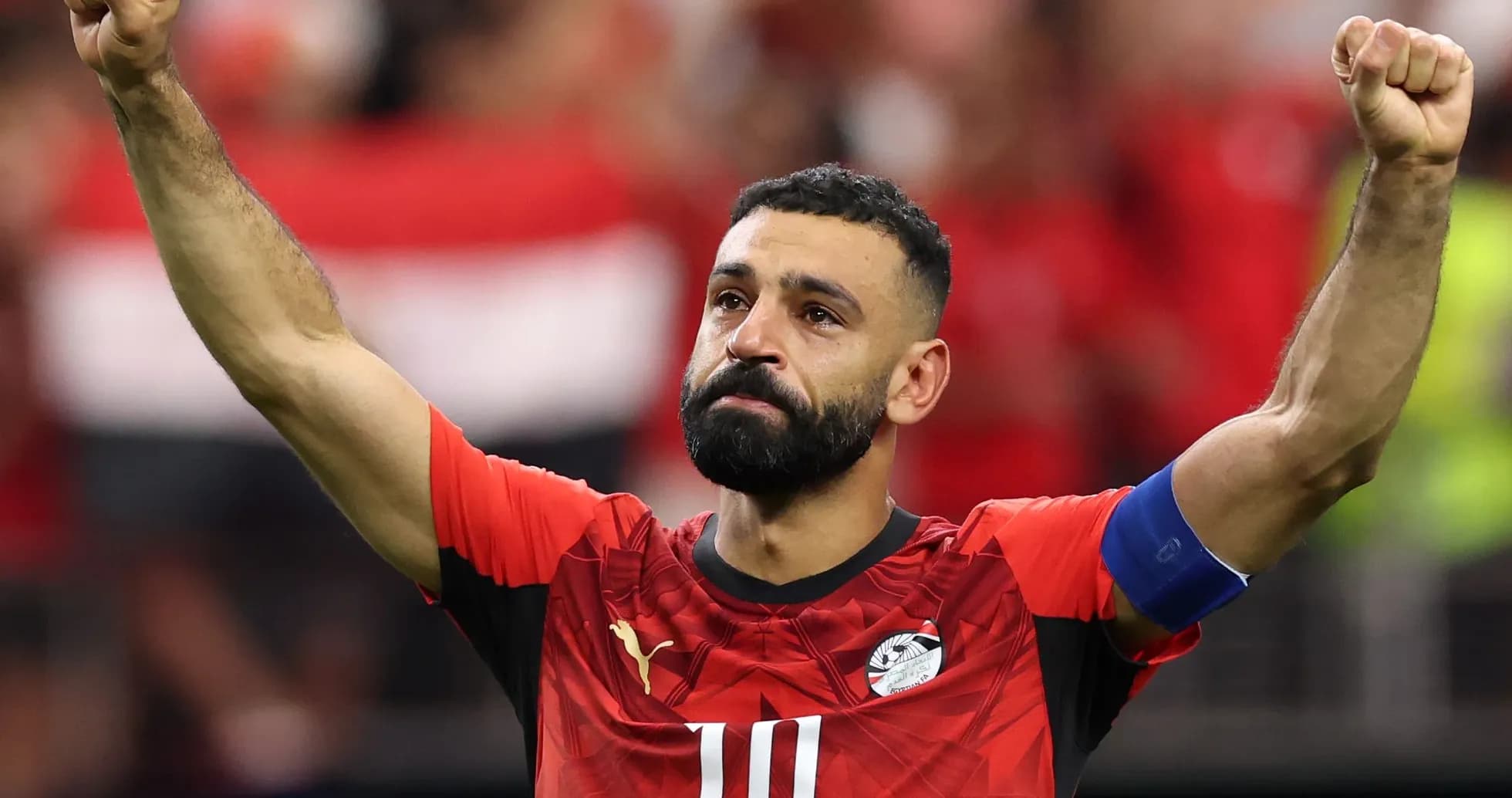 Player celebrating after a match, wearing Egypt jersey Player celebrating after a match, wearing Egypt jersey