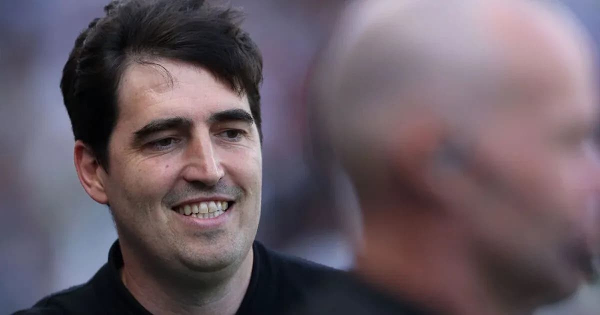 Man smiling with another person in background Man smiling with another person in background