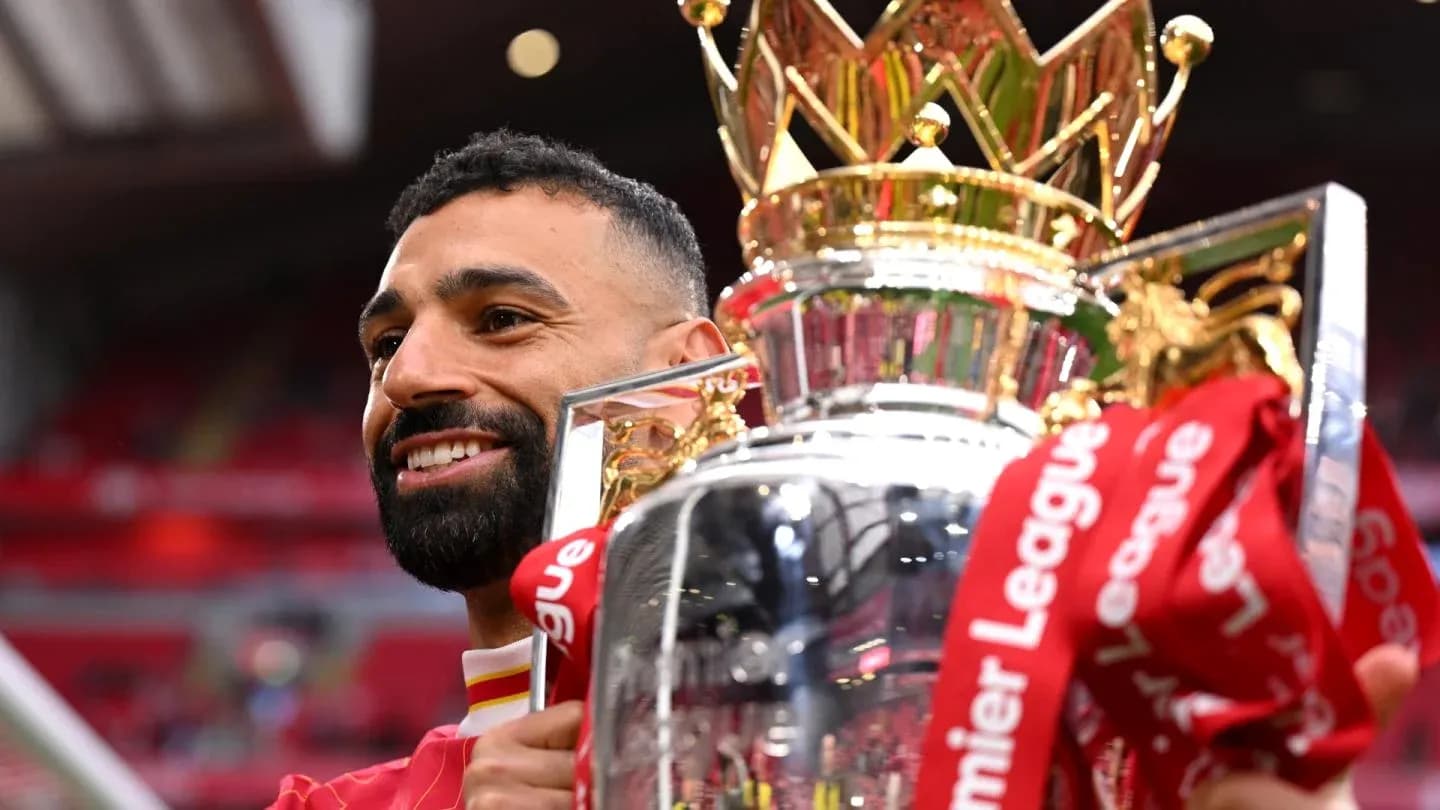 Player holding Premier League trophy with celebration Player holding Premier League trophy with celebration
