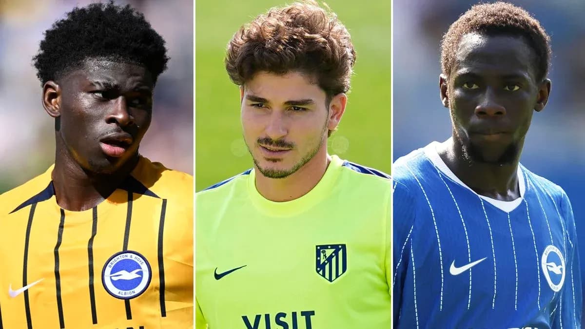Three football players in team jerseys during training Three football players in team jerseys during training