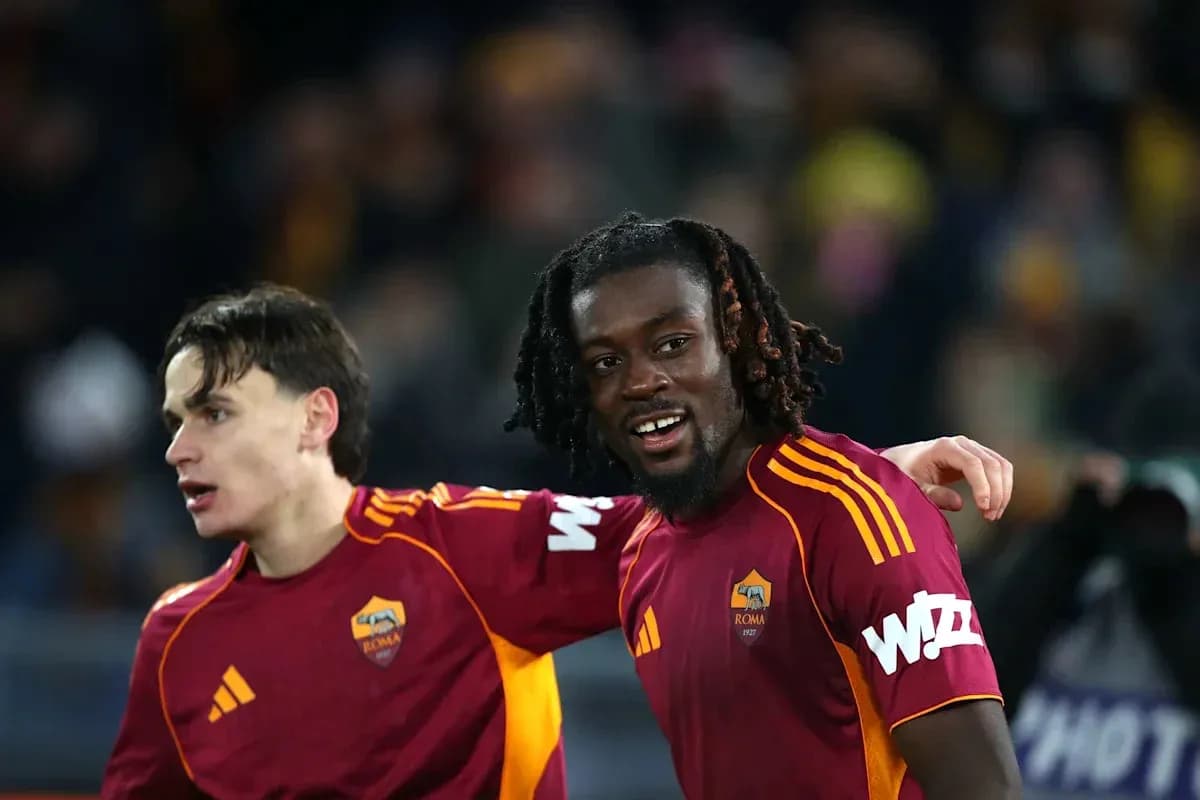 Two AS Roma players celebrating together on pitch Two AS Roma players celebrating together on pitch
