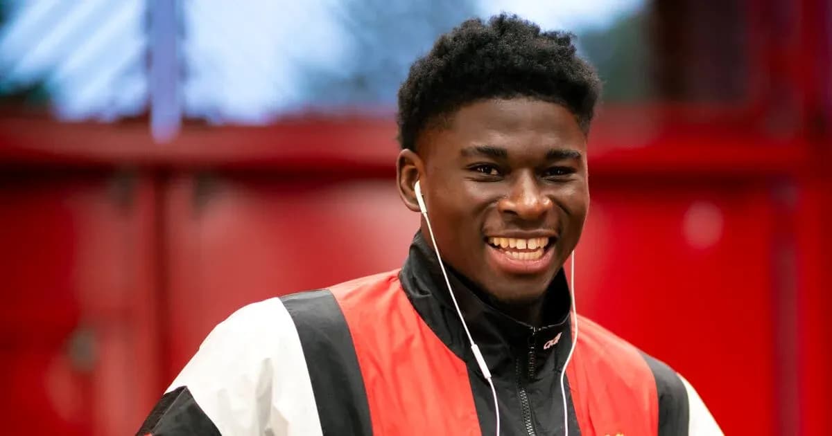 Player smiling while wearing earphones indoors Player smiling while wearing earphones indoors