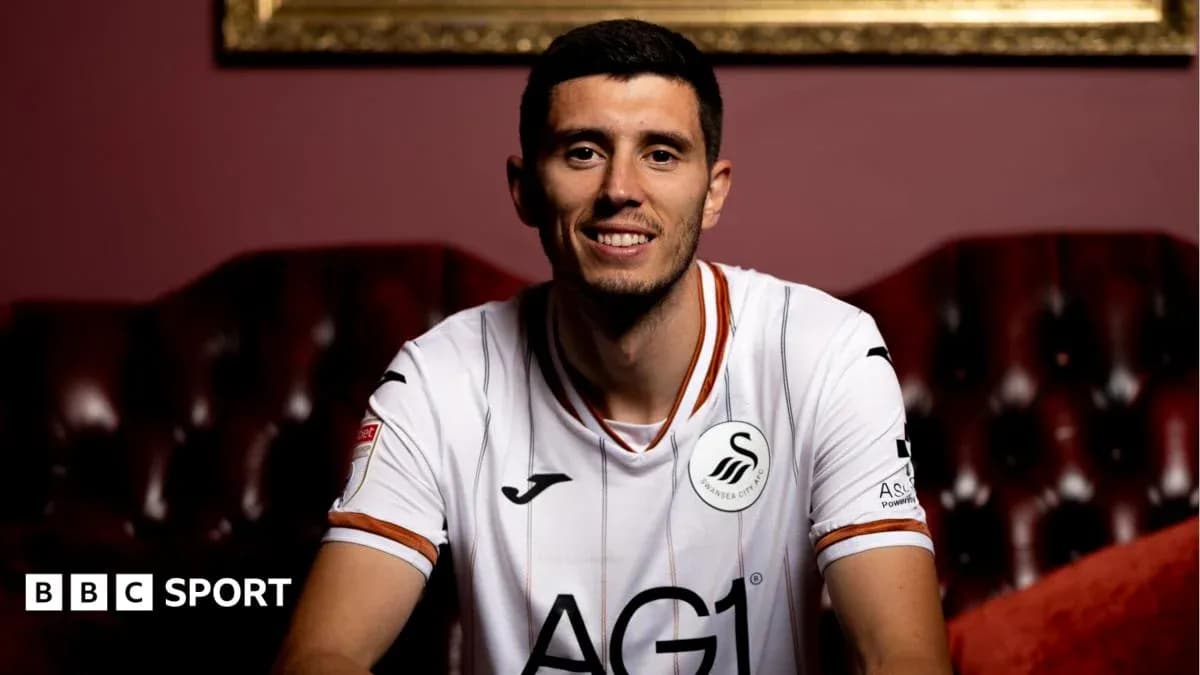Player in Swansea City jersey smiling for portrait Player in Swansea City jersey smiling for portrait
