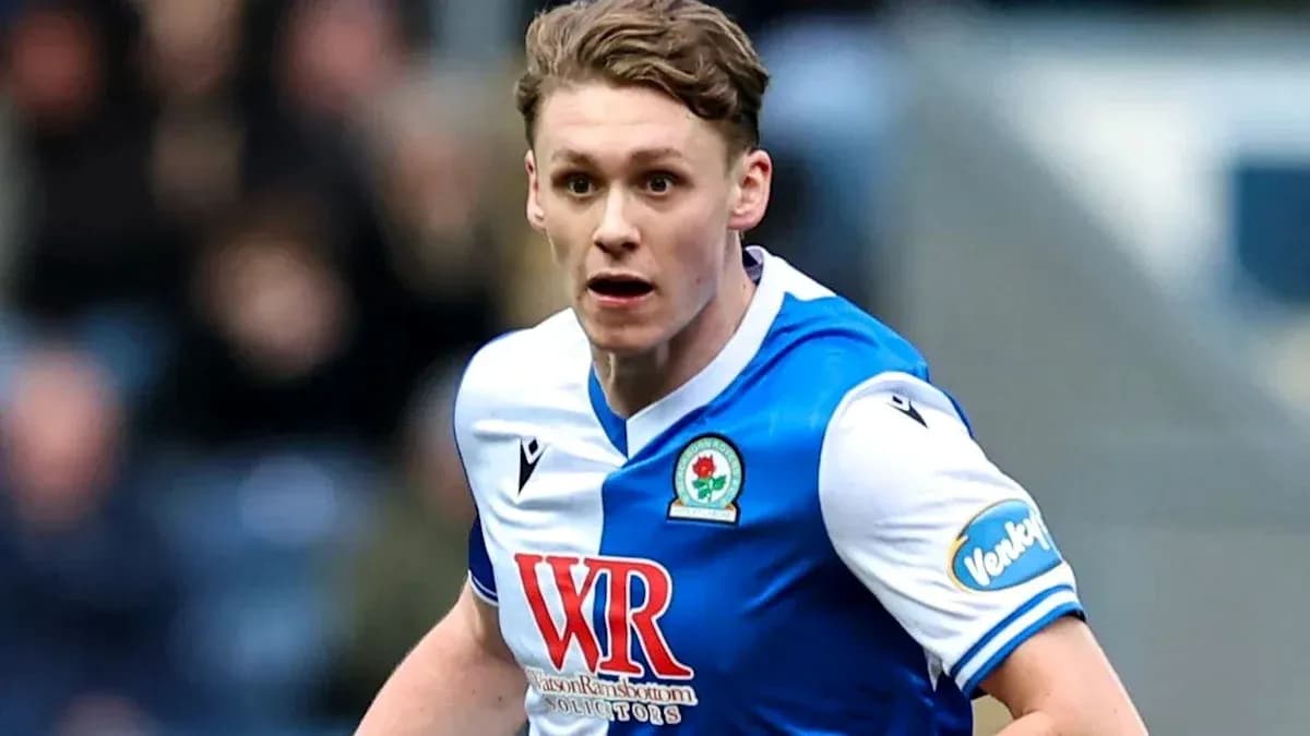 Player in blue and white kit running during match Player in blue and white kit running during match