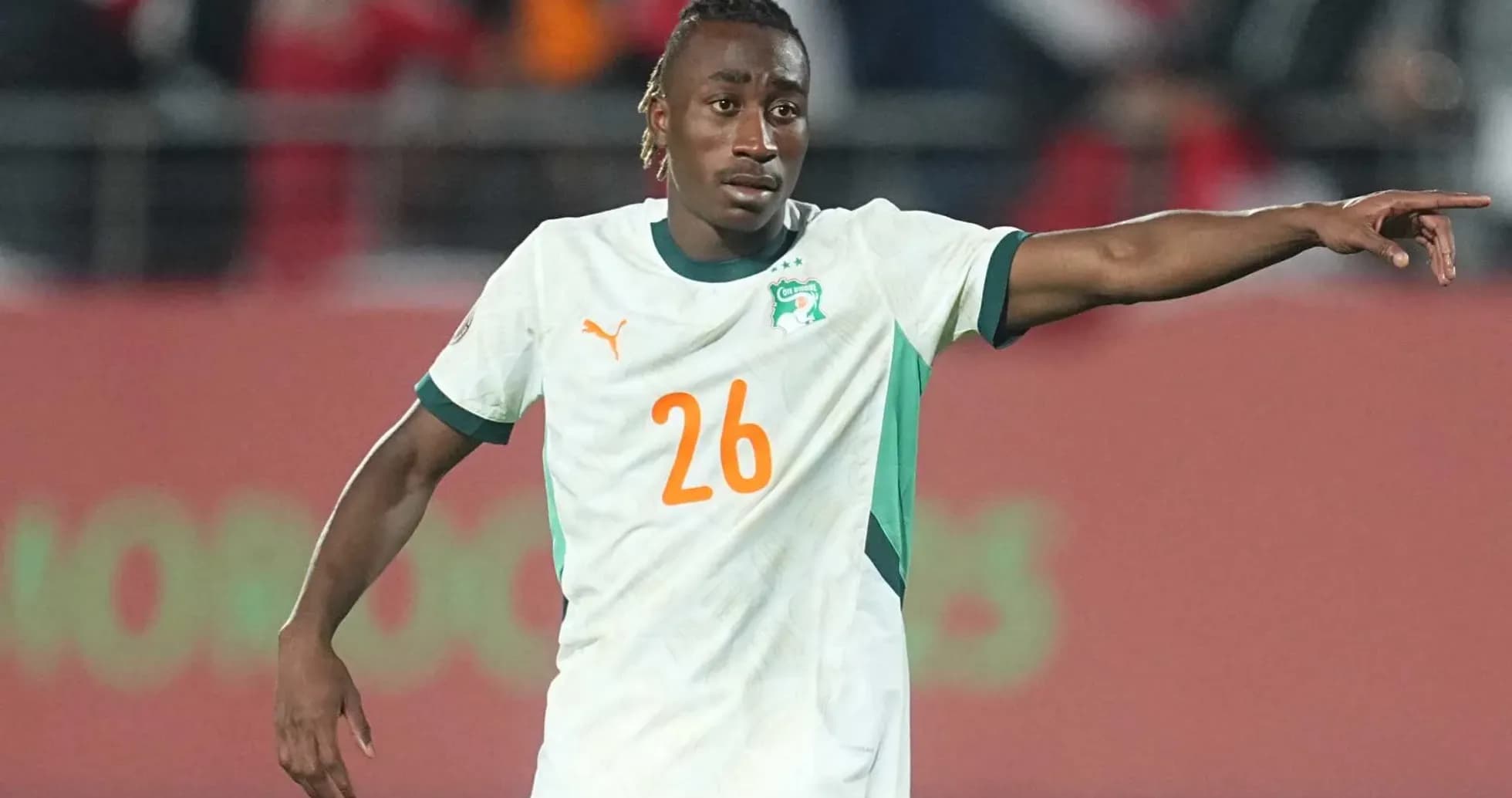 Player in Ivorian jersey signaling during match Player in Ivorian jersey signaling during match
