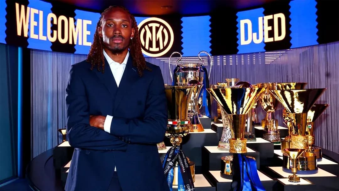 New player posing with trophies at announcement event New player posing with trophies at announcement event
