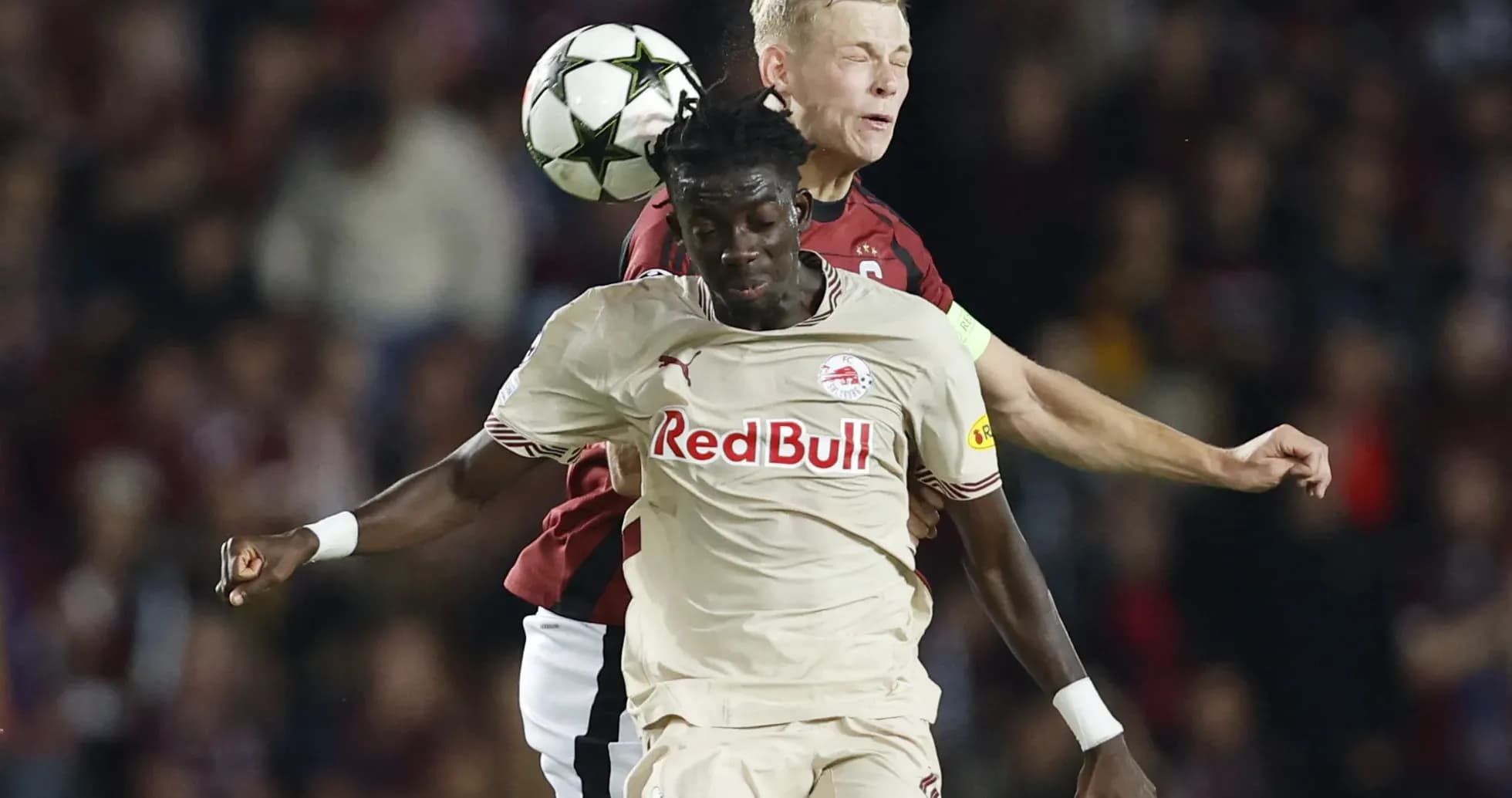 Players challenging for the ball during match Players challenging for the ball during match