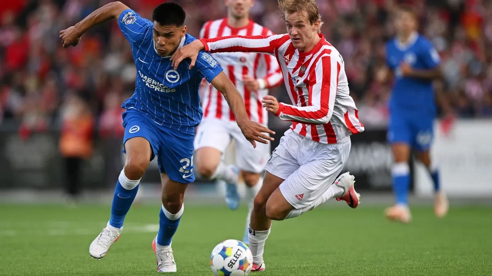 Player in blue evading tackle from opponent in red Player in blue evading tackle from opponent in red
