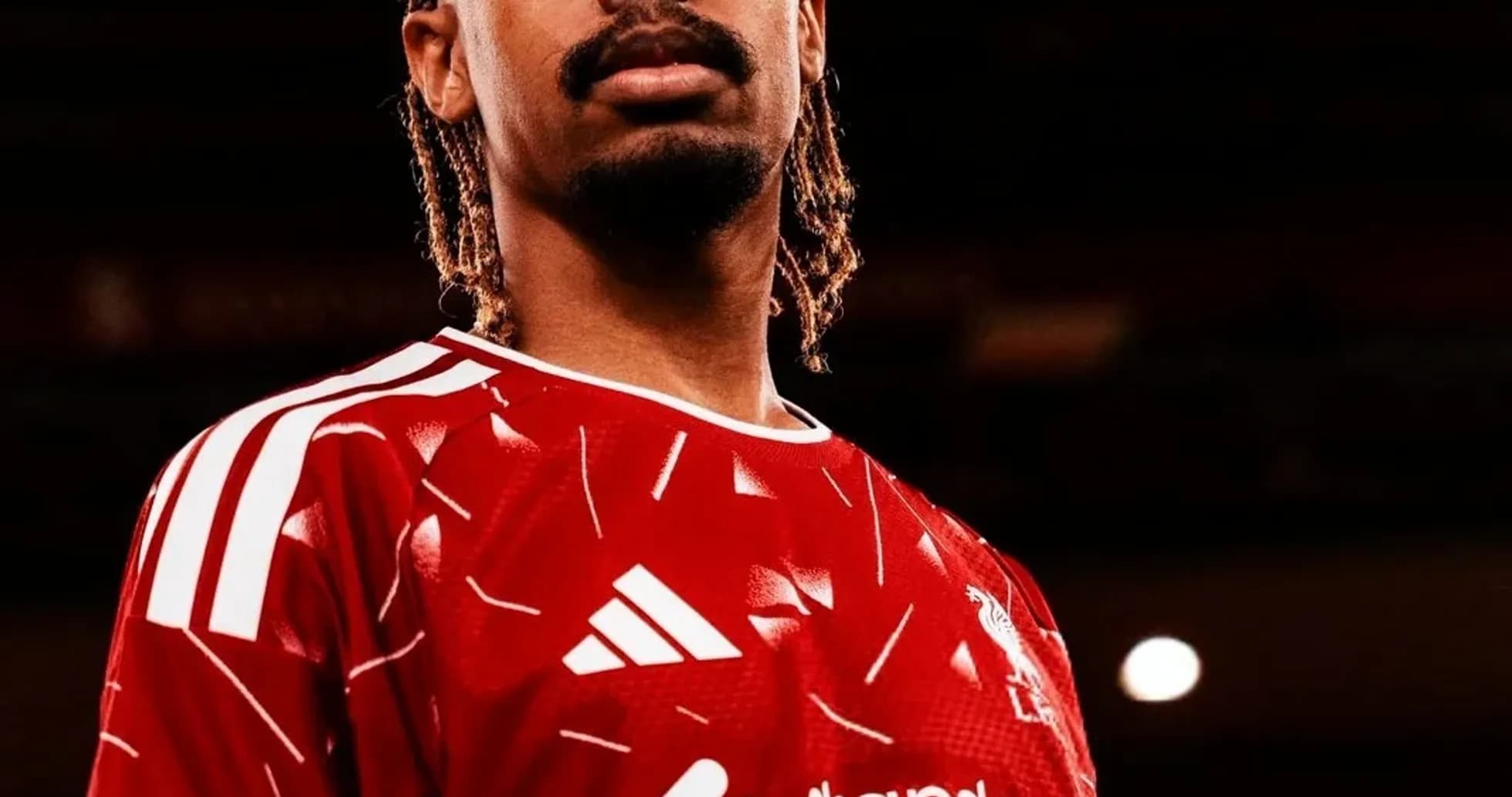 Player posing in red jersey with sponsor logo Player posing in red jersey with sponsor logo