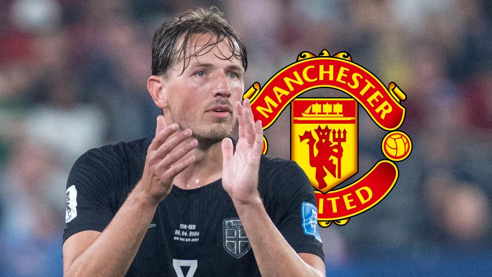Player applauding during match with Manchester United logo Player applauding during match with Manchester United logo