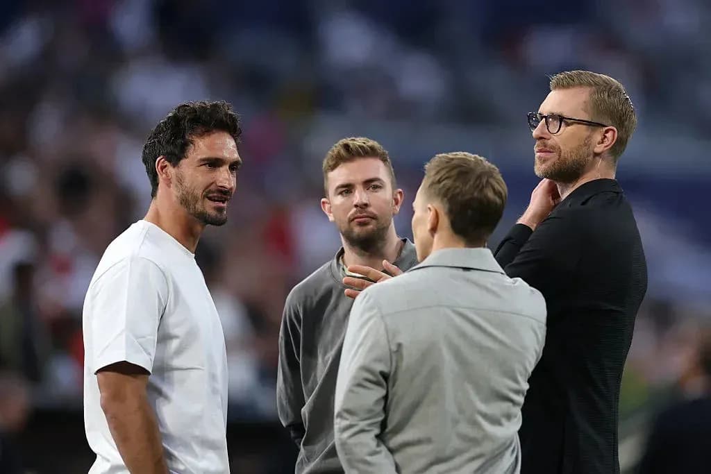 Four men conversing on the football field Four men conversing on the football field