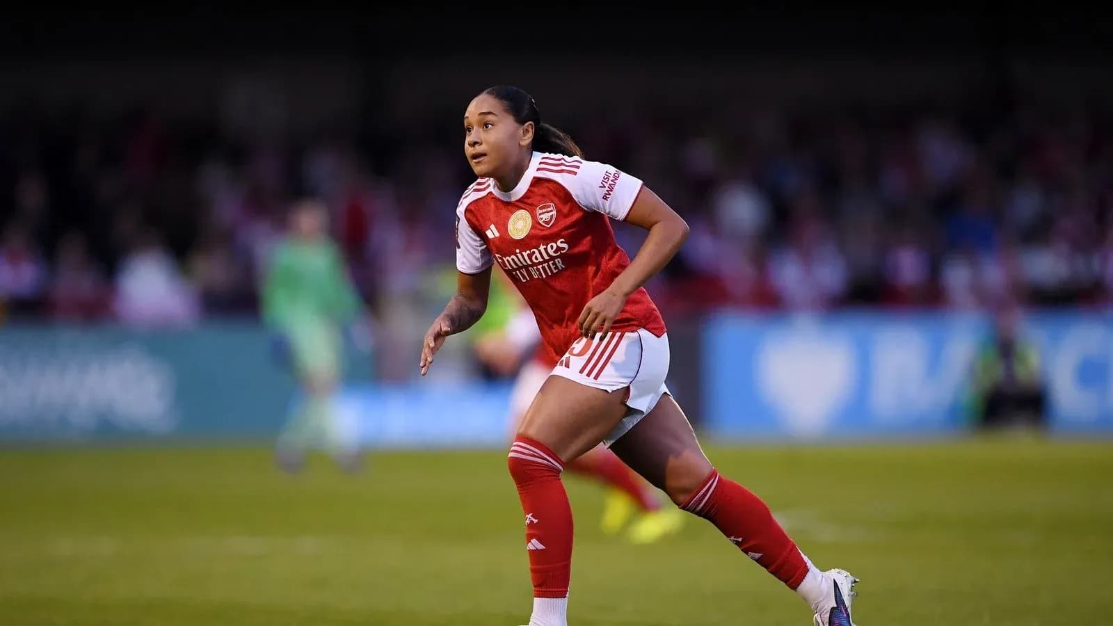Player in Arsenal kit running during match Player in Arsenal kit running during match