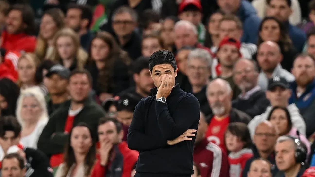 Manager watching match with fans in background Manager watching match with fans in background