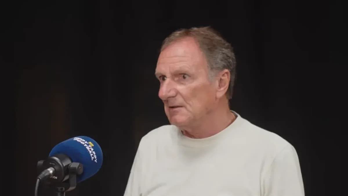 Person speaking into a microphone during interview Person speaking into a microphone during interview