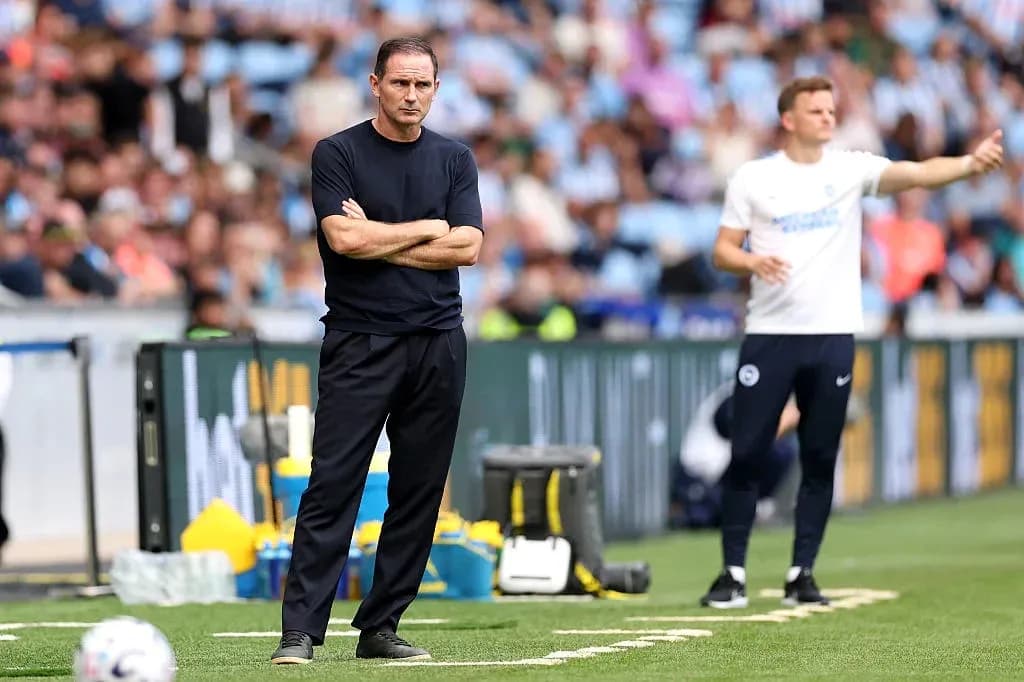 Two football coaches on the sideline during match Two football coaches on the sideline during match
