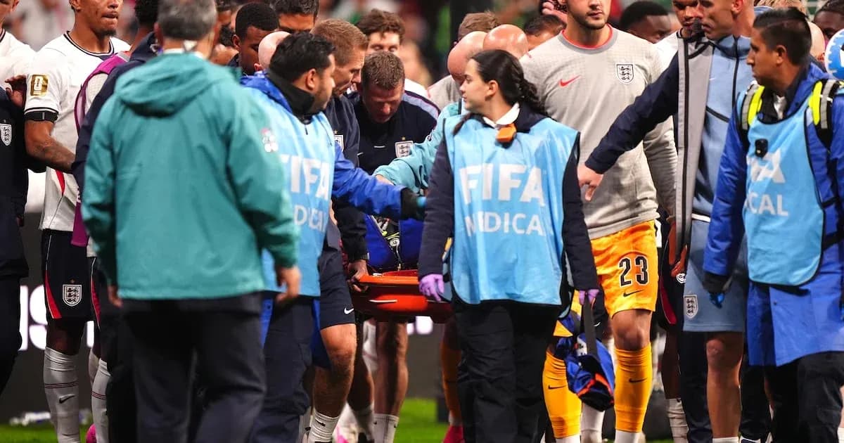 Medical staff attending injured player on stretcher Medical staff attending injured player on stretcher